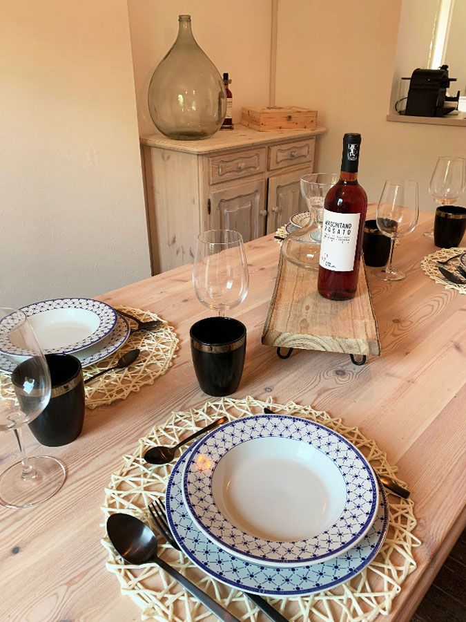 Table set with a good bottle of wine at the Nano Wine Guesthouse.